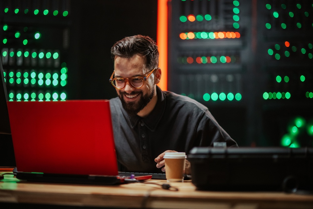 Industrial technology professionals working on computers to understand digital twin vs simulation for predictive performance and process optimization.