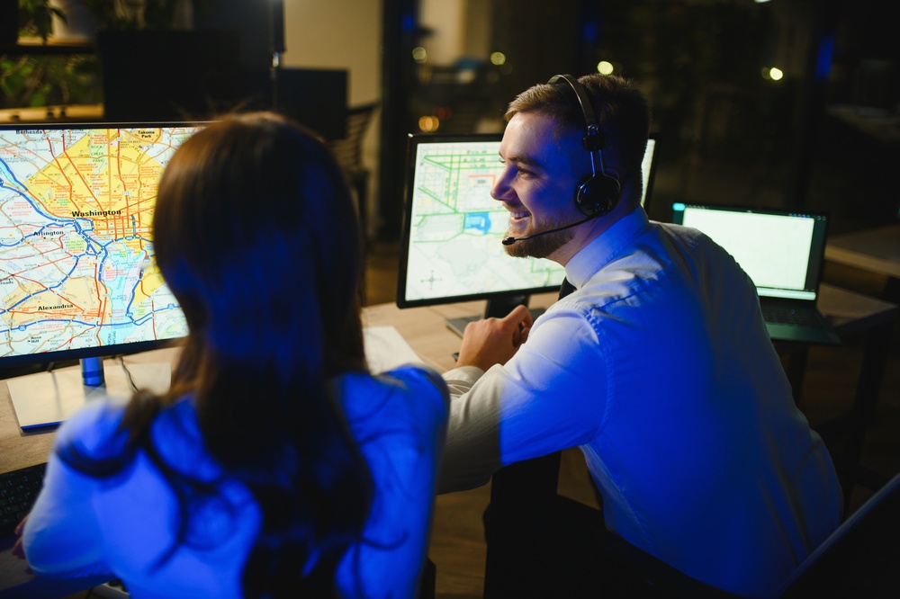 Team members collaborating around a workstation while using process optimization strategies to increase productivity and operational efficiency.
