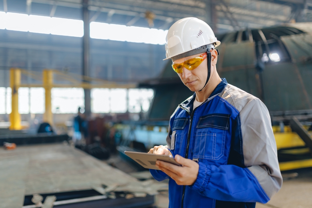 Terminal supervisor watching a manufacturing process, showing digital twin consulting for engineering and port operations
