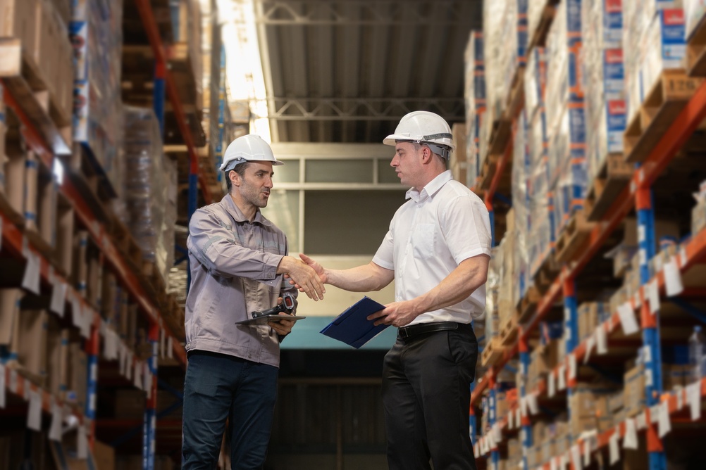 Warehouse operations planner discussing distribution, showing digital twin consulting
