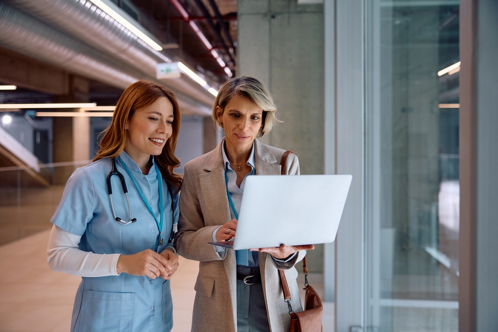 Doctors discussing bed capacity in a hospital corridor, a key use of digital twins in healthcare
