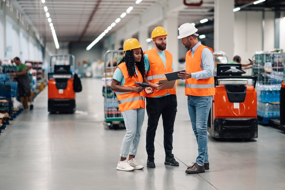 Project manager reviewing a warehouse optimization layout plan on a tablet