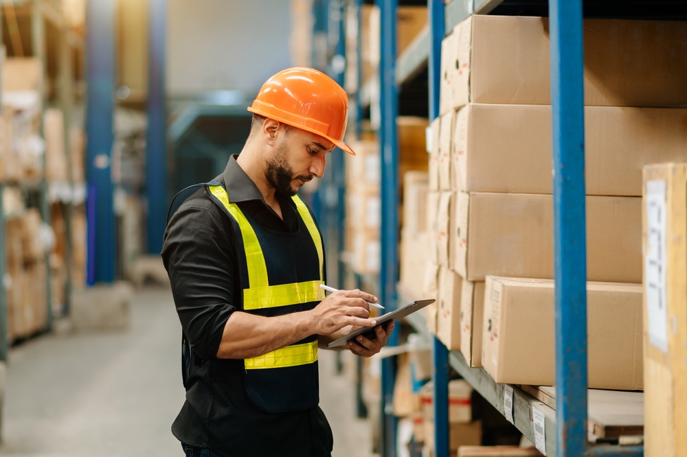 Operations manager checking warehouse optimization results on a tablet